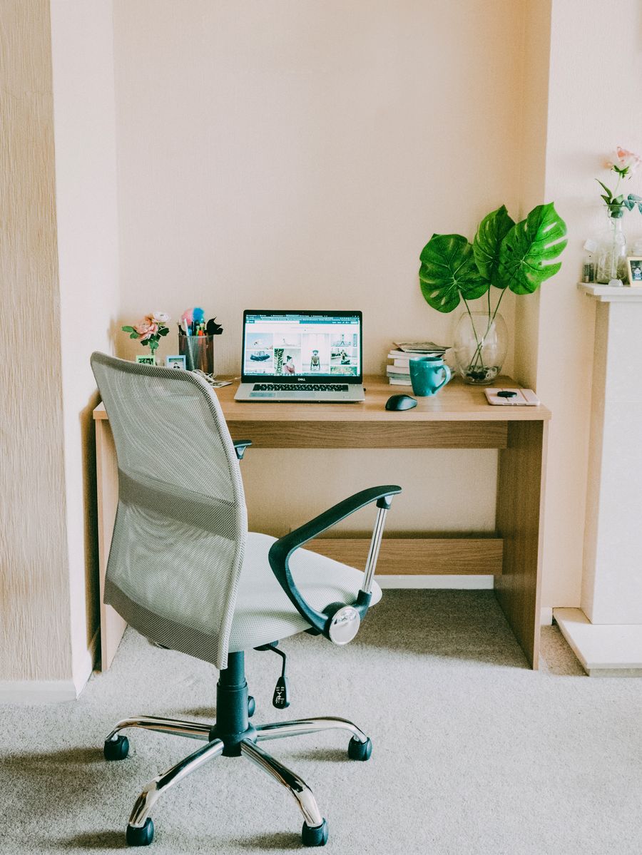 A simple home workspace with a laptop and desk
